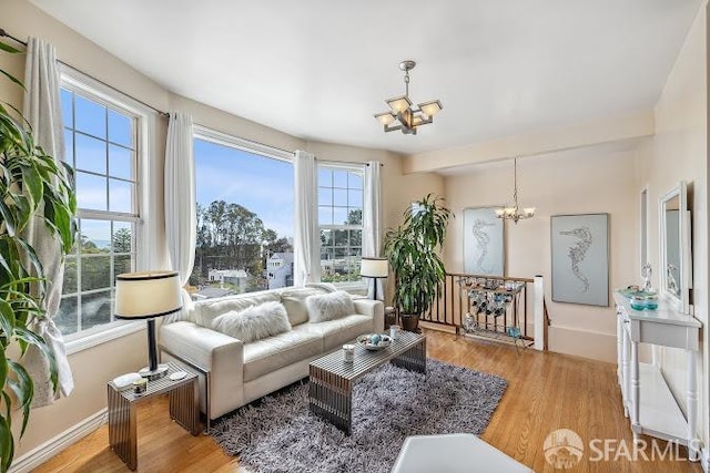 living room with a notable chandelier and light hardwood / wood-style flooring