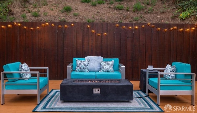 view of patio / terrace with an outdoor living space with a fire pit and a deck