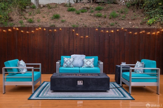 view of patio with a deck and an outdoor living space with a fire pit