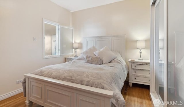 bedroom featuring light hardwood / wood-style floors and a closet