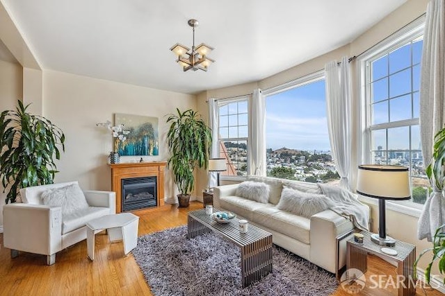 living room with a notable chandelier and light hardwood / wood-style flooring