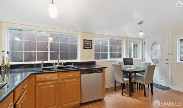 kitchen featuring sink, decorative light fixtures, vaulted ceiling, and dishwasher