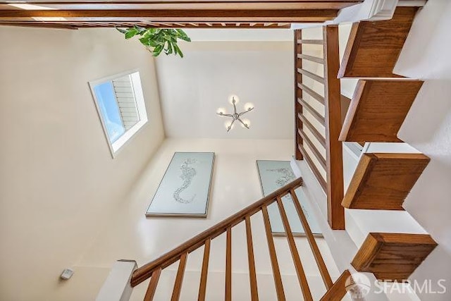 stairway with an inviting chandelier