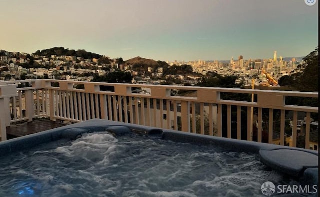 balcony at dusk with a hot tub