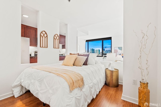 bedroom featuring white refrigerator and light wood-type flooring