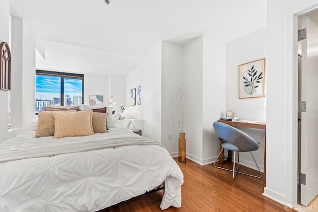 bedroom featuring floor to ceiling windows and hardwood / wood-style flooring