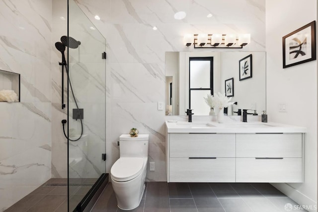 bathroom with tile patterned floors, vanity, an enclosed shower, and toilet