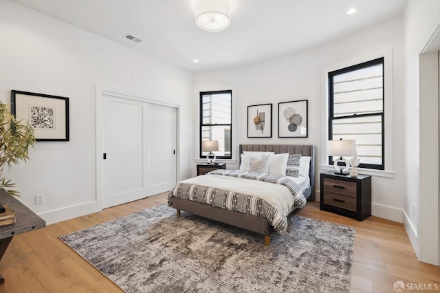 bedroom with a closet and light wood-type flooring