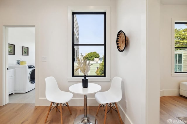 dining room with light hardwood / wood-style flooring and washer / dryer