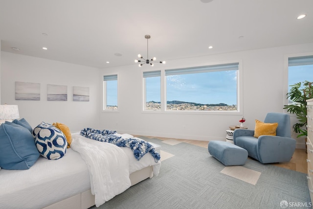 bedroom with an inviting chandelier and hardwood / wood-style floors