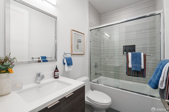 full bathroom with vanity, enclosed tub / shower combo, and toilet