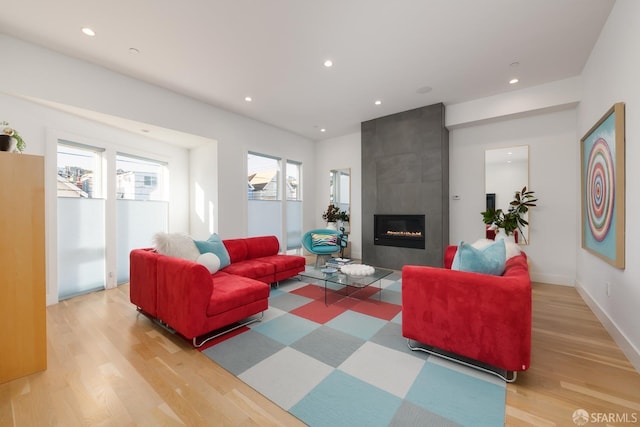 living room with hardwood / wood-style floors and a tile fireplace