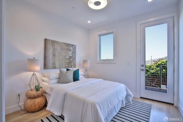 bedroom featuring access to outside and light hardwood / wood-style flooring