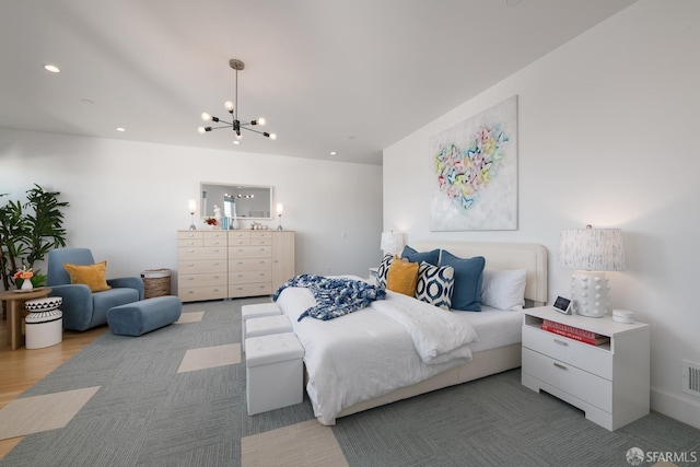 bedroom with wood-type flooring and a chandelier