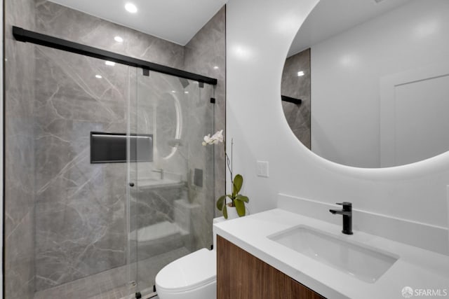 bathroom with vanity, toilet, and an enclosed shower