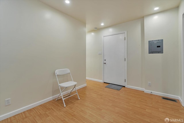 interior space featuring recessed lighting, visible vents, light wood-style flooring, and electric panel