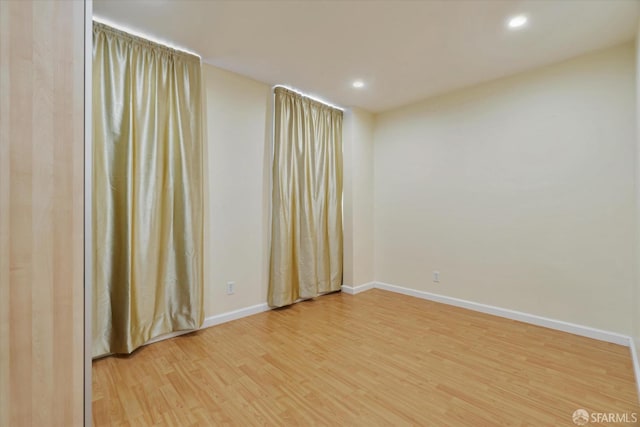 unfurnished room featuring baseboards, recessed lighting, and light wood-style flooring