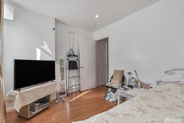 bedroom featuring recessed lighting and wood finished floors