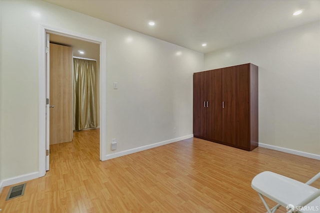 unfurnished bedroom with recessed lighting, baseboards, visible vents, and light wood finished floors