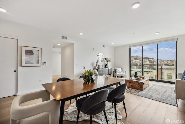 dining space with light hardwood / wood-style floors