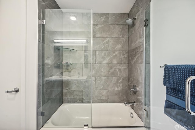 bathroom featuring shower / bath combination with glass door