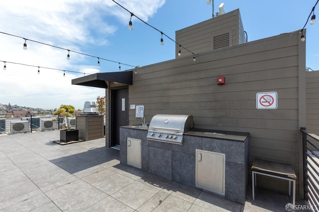 view of patio featuring sink, exterior kitchen, and area for grilling