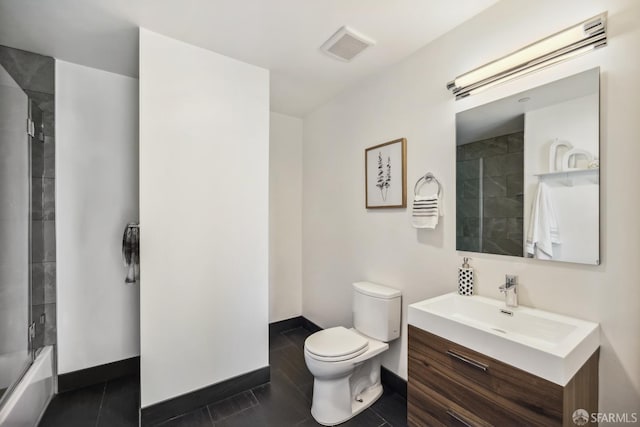 full bathroom with tile patterned floors, combined bath / shower with glass door, vanity, and toilet