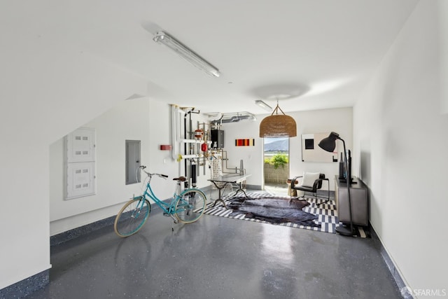 exercise room featuring electric panel and baseboards