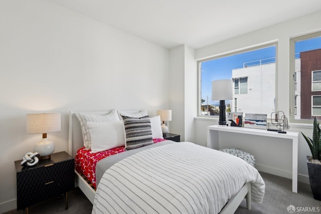 bedroom featuring multiple windows, carpet, and baseboards