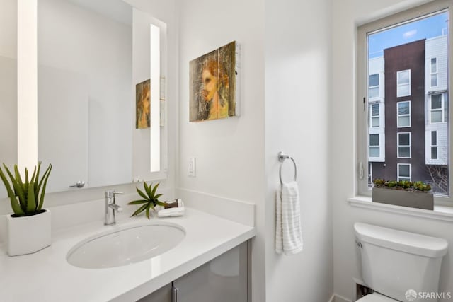 half bathroom with toilet and vanity