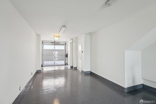 garage with baseboards and a garage door opener