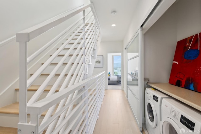 laundry room with independent washer and dryer, light wood-style floors, and recessed lighting