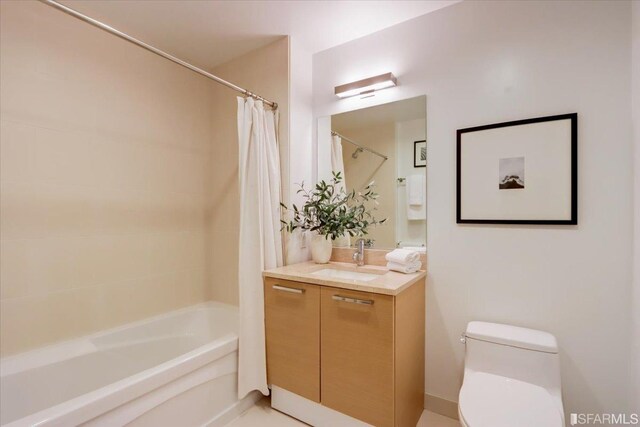 bathroom with toilet, vanity, and shower / bath combination with curtain