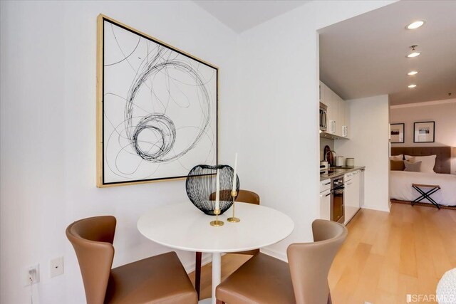 dining room with recessed lighting and light wood-style floors