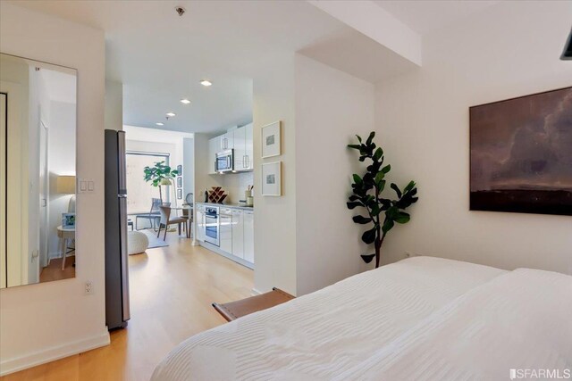 bedroom featuring recessed lighting and light wood-type flooring