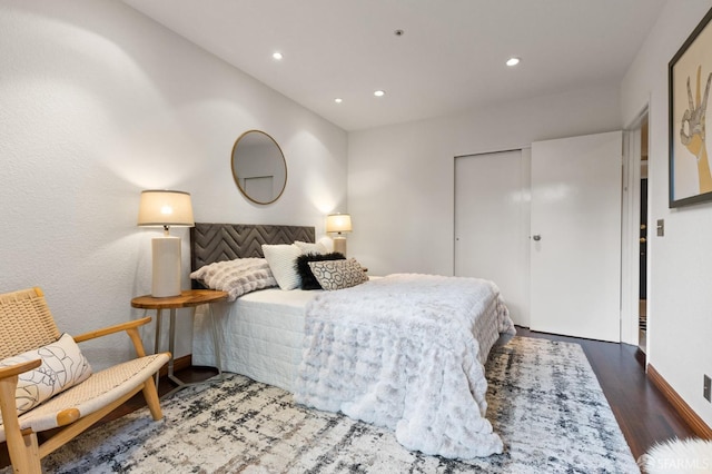 bedroom with dark hardwood / wood-style flooring