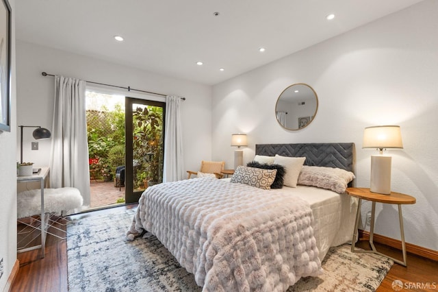 bedroom with access to outside and hardwood / wood-style floors