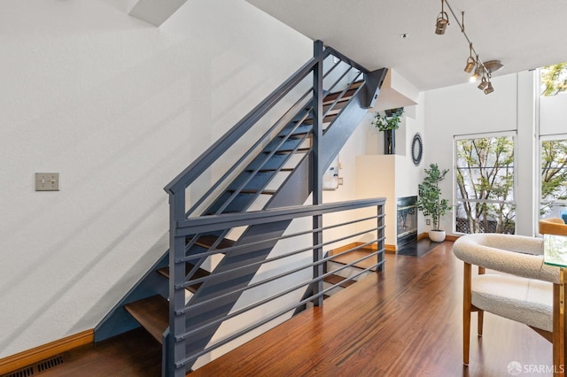 stairs featuring hardwood / wood-style flooring