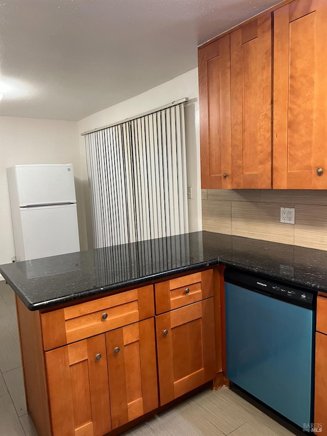 1521-1527 Valle Vista Ave, Vallejo, CA 94589 - kitchen with dishwashing machine, freestanding refrigerator, a peninsula, and brown cabinetry