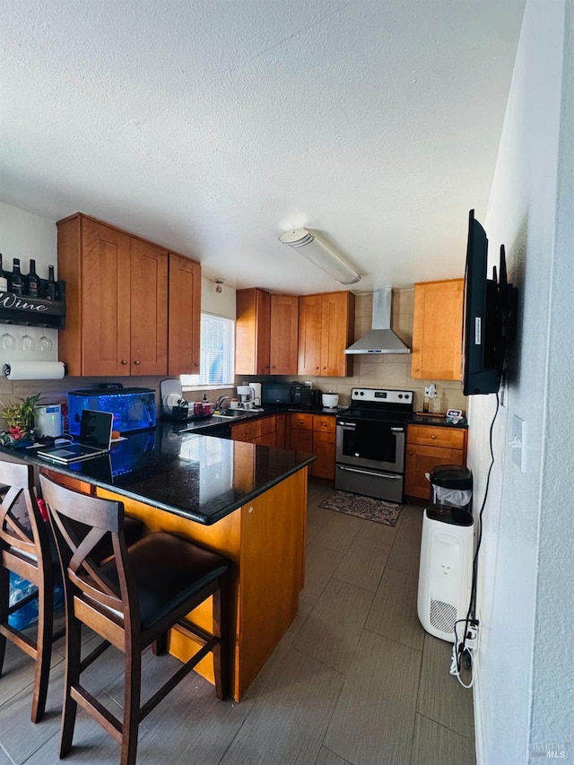 1521-1527 Valle Vista Ave, Vallejo, CA 94589 - kitchen with stainless steel electric range, wall chimney range hood, a peninsula, brown cabinets, and a textured ceiling