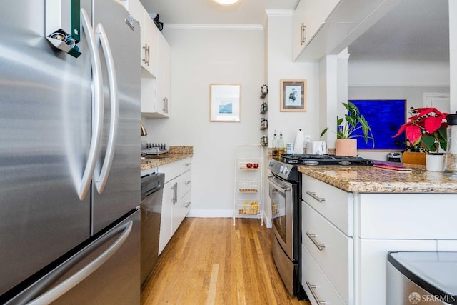 1490 Francisco St Unit 3, San Francisco, CA 94123 - kitchen with stainless steel appliances, light wood finished floors, ornamental molding, white cabinets, and light stone countertops