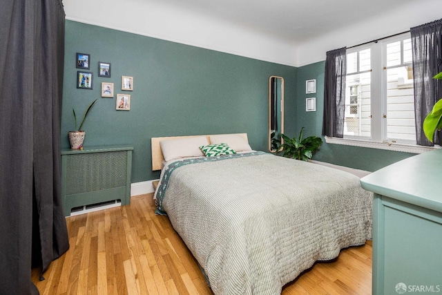 1490 Francisco St Unit 3, San Francisco, CA 94123 - bedroom with radiator heating unit, light wood-style flooring, and baseboards