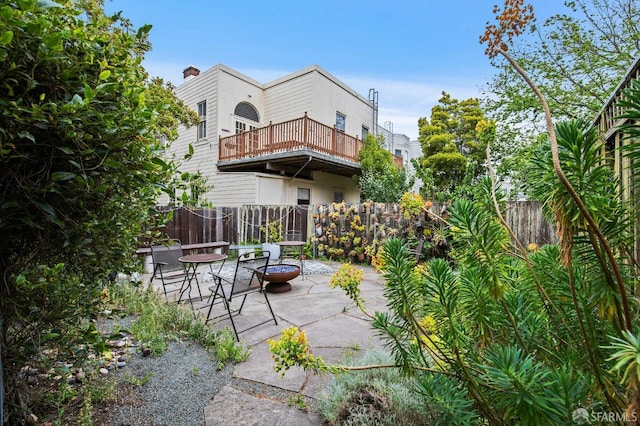 view of patio / terrace with a balcony and an outdoor fire pit