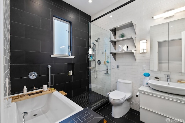 full bathroom featuring vanity, plus walk in shower, tile walls, tile patterned flooring, and toilet