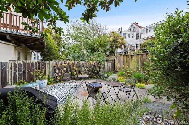 view of patio / terrace featuring a balcony and an outdoor fire pit