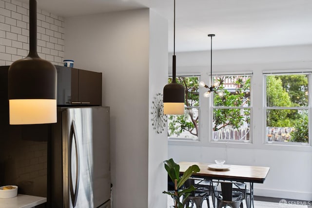 kitchen featuring stainless steel refrigerator and dark brown cabinetry