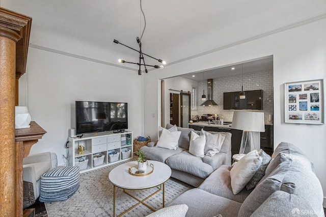 living room with brick wall and a notable chandelier