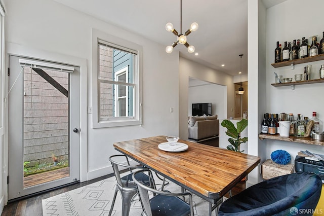 dining room featuring an inviting chandelier and dark wood-type flooring