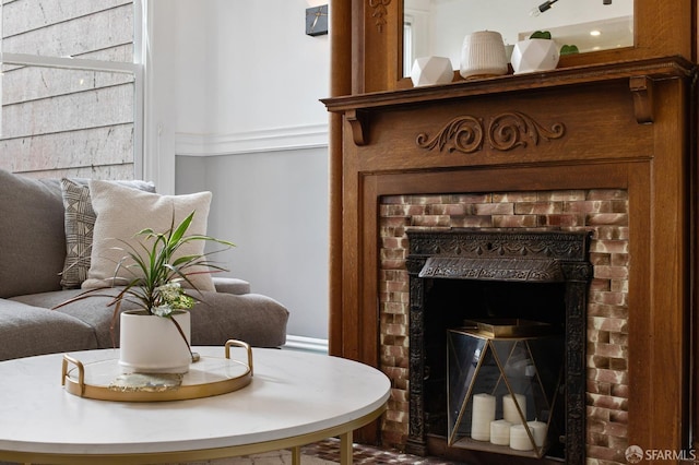 living area with a brick fireplace