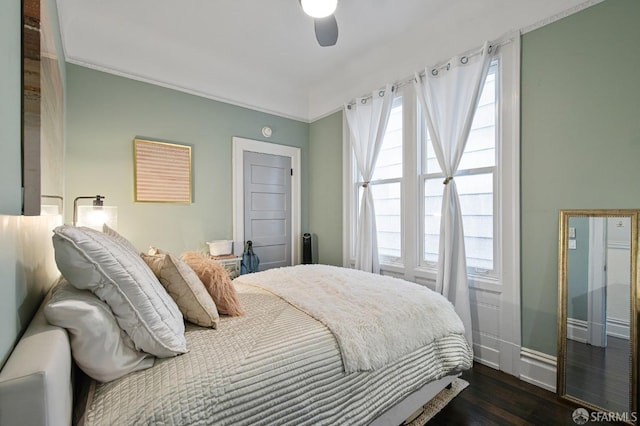 bedroom with ceiling fan and dark wood-type flooring